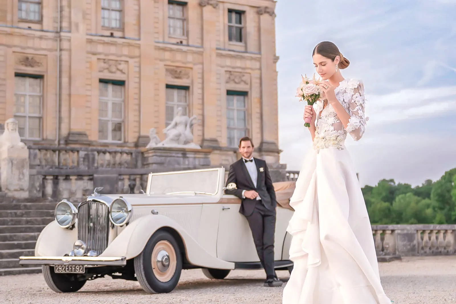 Paris wedding photographer captures luxury château elopement couple portraits at Vaux-le-Vicomte with couture gown and vintage convertible - premium wedding photography