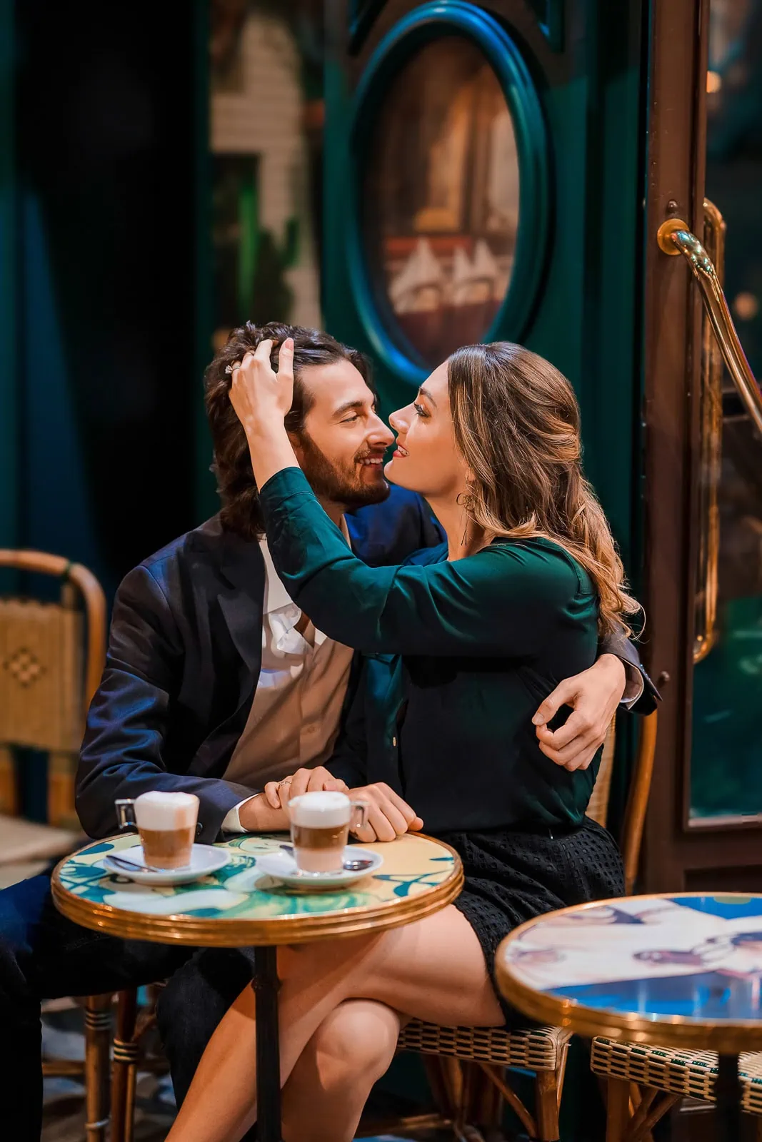 Couple connecting at colorful Montmartre cafe at night with cappuccinos, Paris couple photographer session