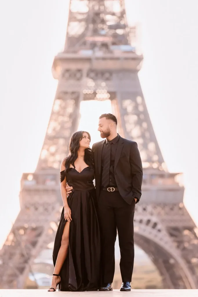 Stylish couple in black celebrating anniversary at Trocadéro during fall with Eiffel Tower backdrop, Paris photographer session