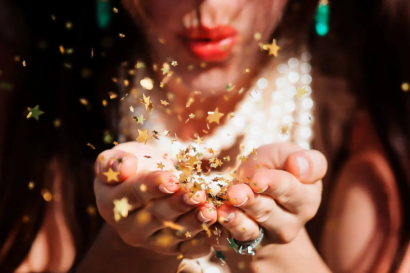 Bride blowing golden star confetti frozen mid-air during Paris bridal photoshoot, professional photographer session