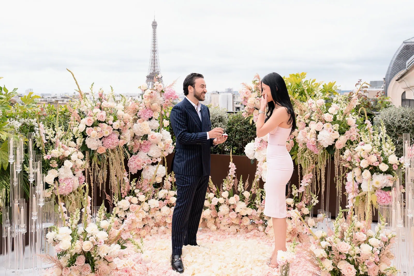 Emotional proposal with heart-shaped rose bed at Peninsula Hotel Secret Table with Eiffel Tower, Paris proposal photographer