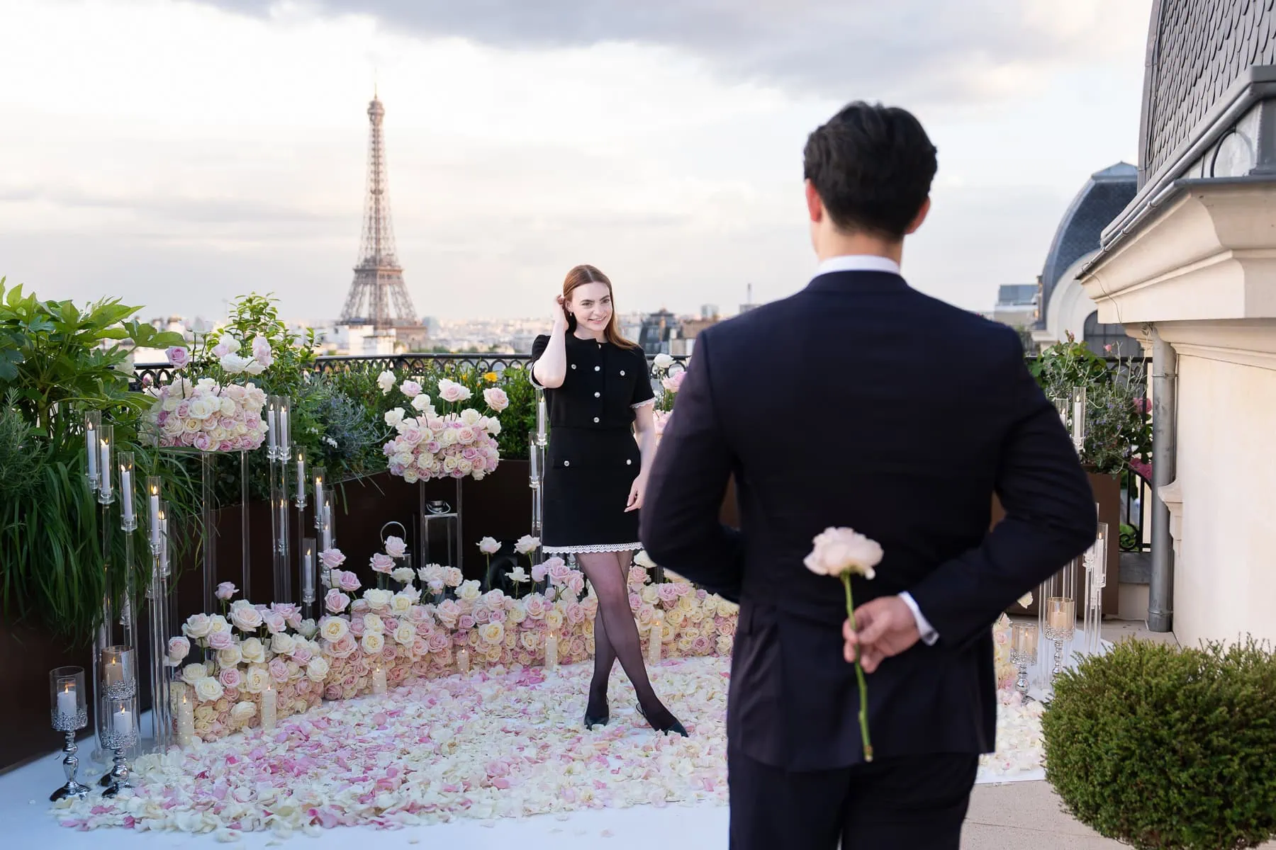 Golden hour Paris proposal at the Peninsula hotel Secret Table with Eiffel Tower view, pink rose, engagement ring display, and rose floral installation.